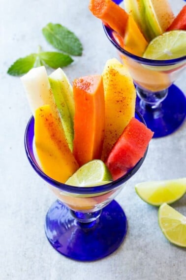 This recipe for Mexican fruit cups is spears of tropical fruit, stacked in a glass and sprinkled with chile lime seasoning. A refreshing and unique take on fruit salad!