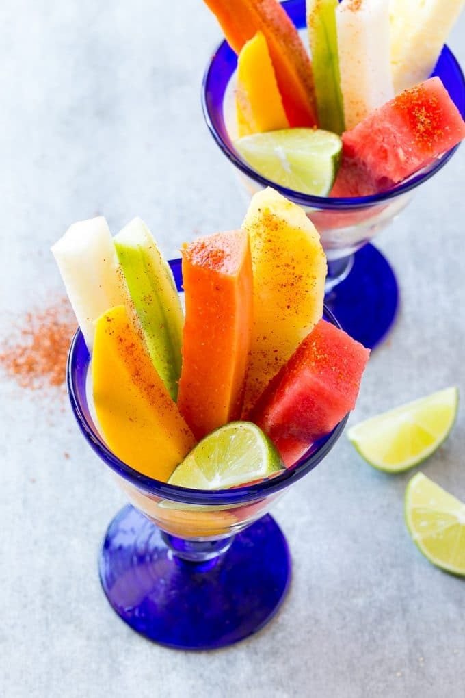 Mexican fruit cups with an assortment of fruit, topped with chili lime seasoning.