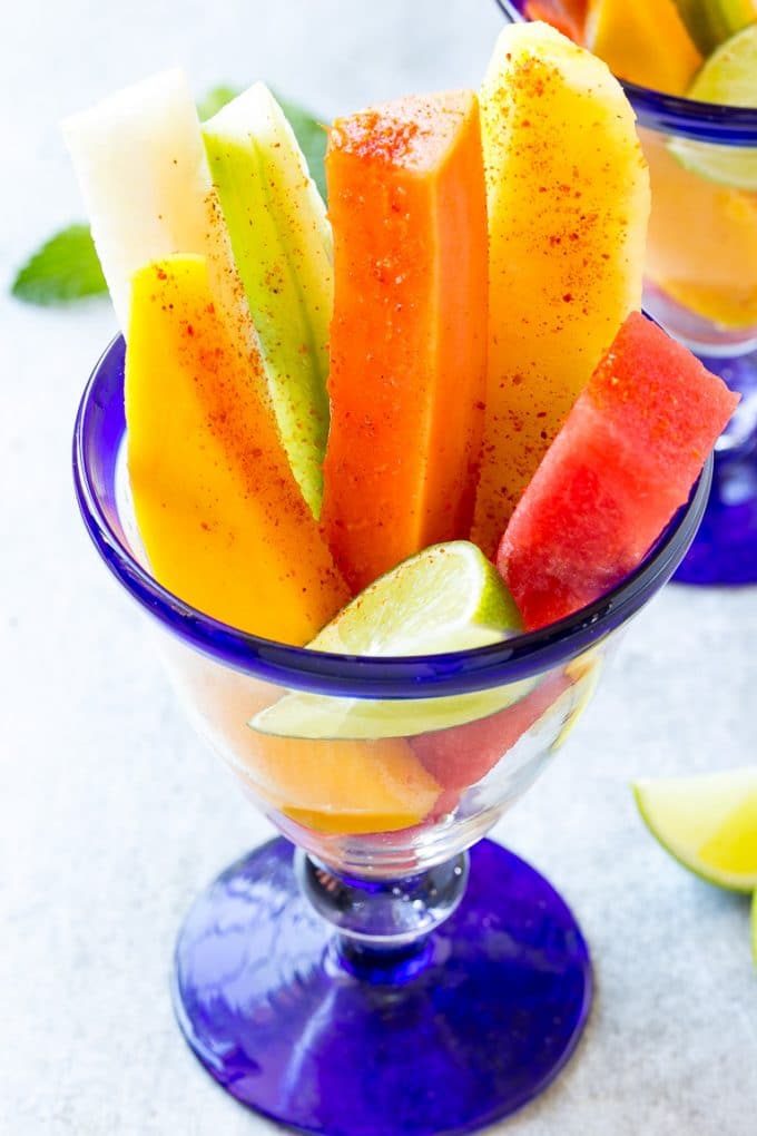 Fruit cups filled with watermelon, cucumber, papaya and mango.