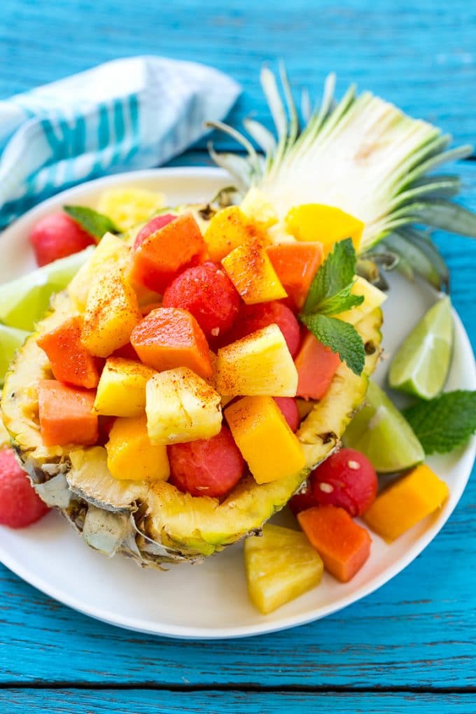 Mexican fruit salad served inside a pineapple half.