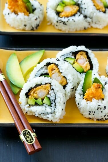 This recipe for shrimp tempura roll is crispy shrimp with avocado and cucumber, all wrapped up in seasoned rice. Making sushi at home is actually quite fun and easy to do!