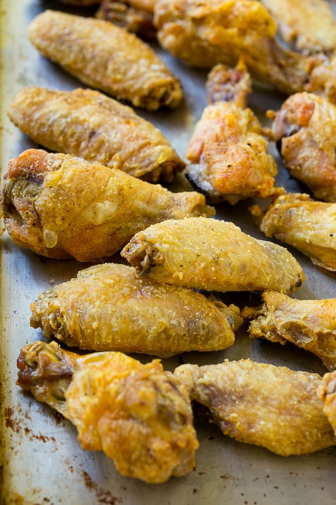 Crispy baked chicken wings on a sheet pan.