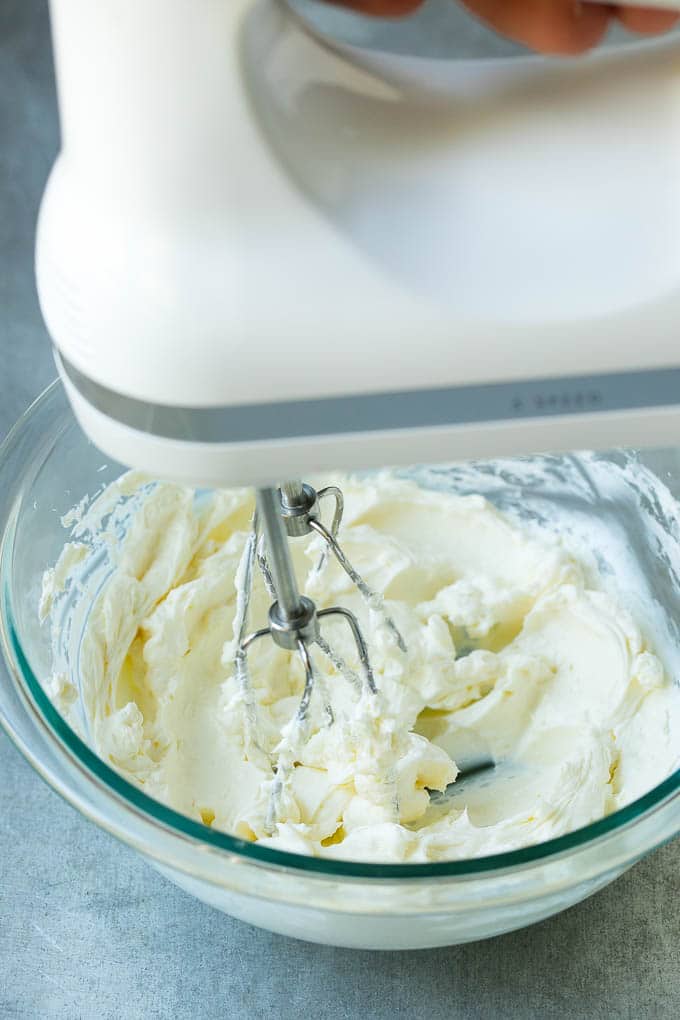 A mixer whipping up cream cheese for fruit dip.
