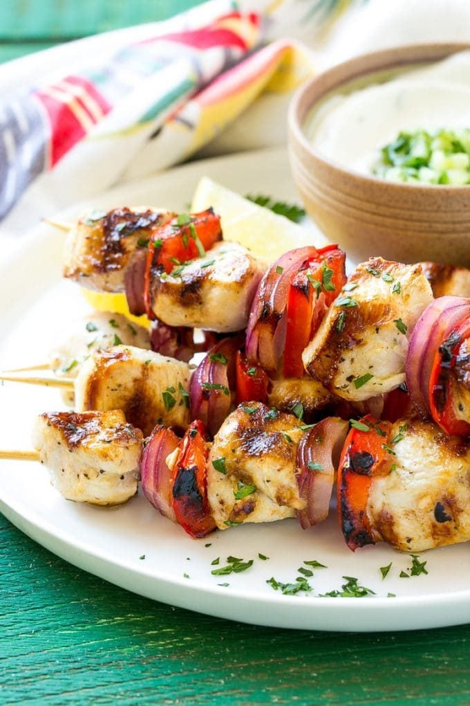 A stack of Greek chicken skewers made with peppers and onions.