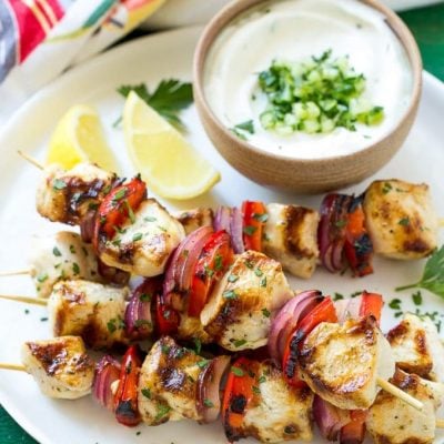 This recipe for Greek chicken kabobs is garlic and herb marinated chicken and colorful vegetables, skewered and grilled to perfection. Serve these skewers with a creamy cucumber yogurt dip for an easy and delicious dinner!