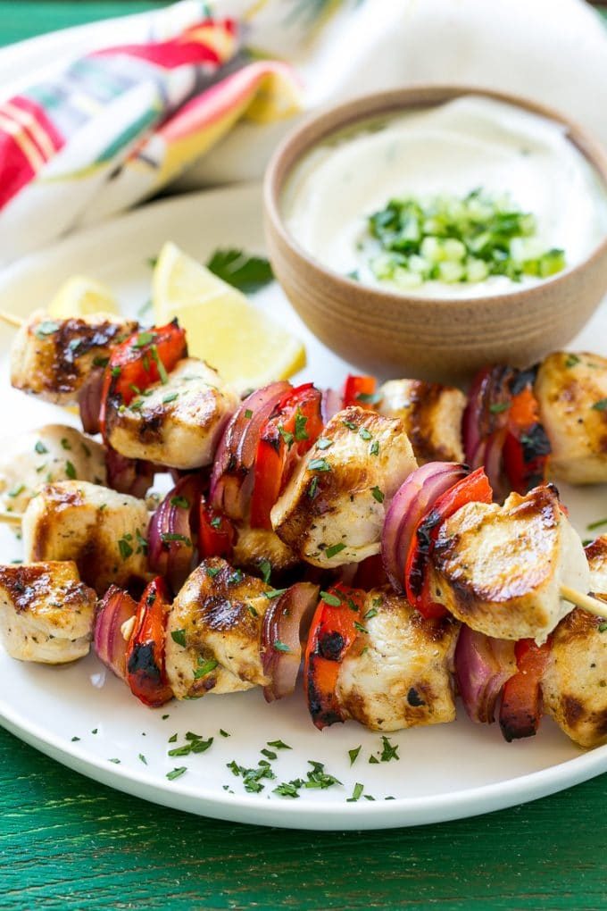 Greek style chicken kabobs topped with fresh parsley.