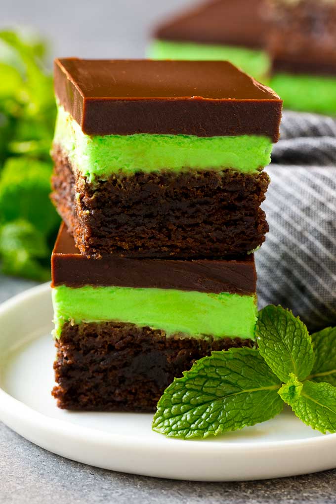 A stack of mint brownies topped with mint and chocolate frostings.