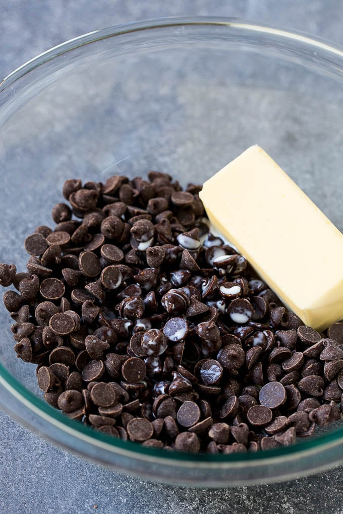 Chocolate chips, butter and cream in a mixing bowl.
