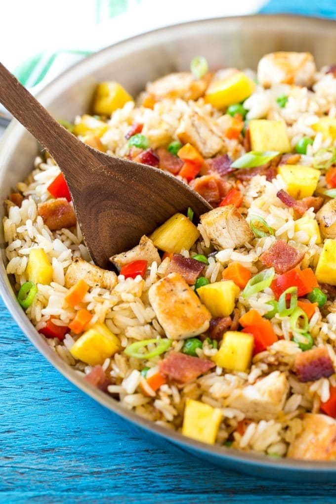 This recipe for pineapple fried rice is loaded with chicken, bacon, crunchy veggies and juicy pineapple. A simple and easy main course or side dish that's MUCH better than take out!