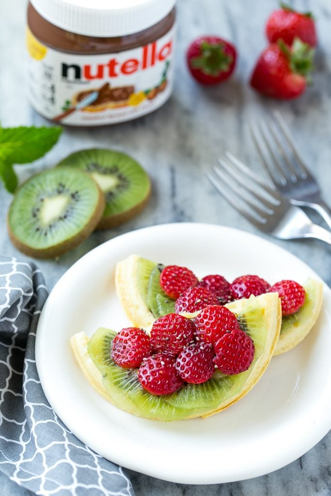 Have fun with your breakfast and turn regular old toaster waffles into watermelon designs with Nutella and fresh fruit! AD