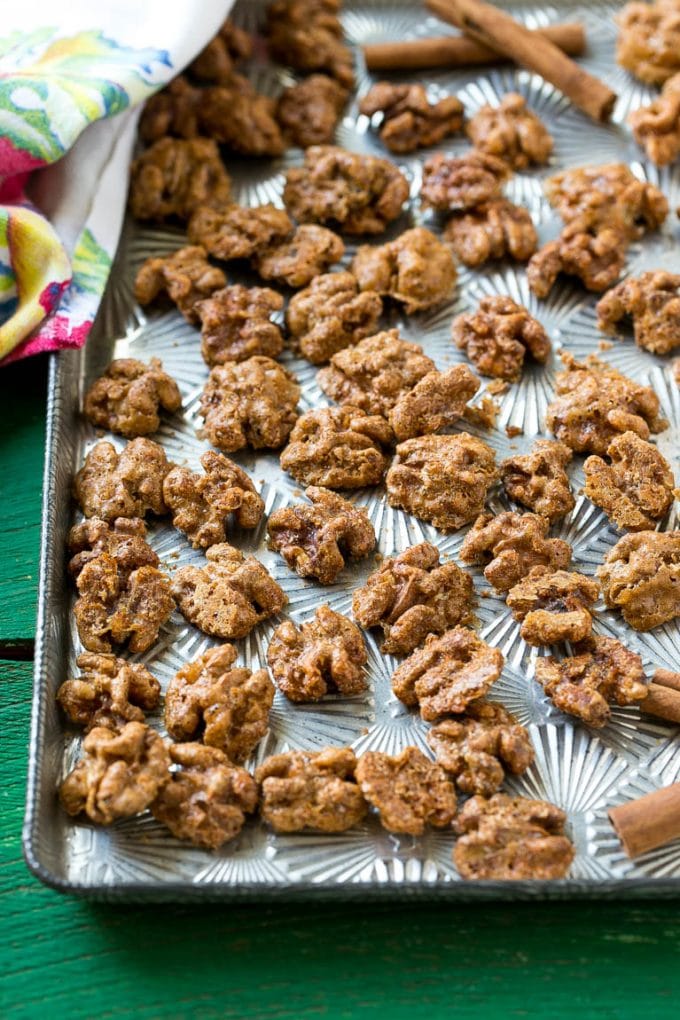 A sheet pan with a layer of glazed walnut halves.