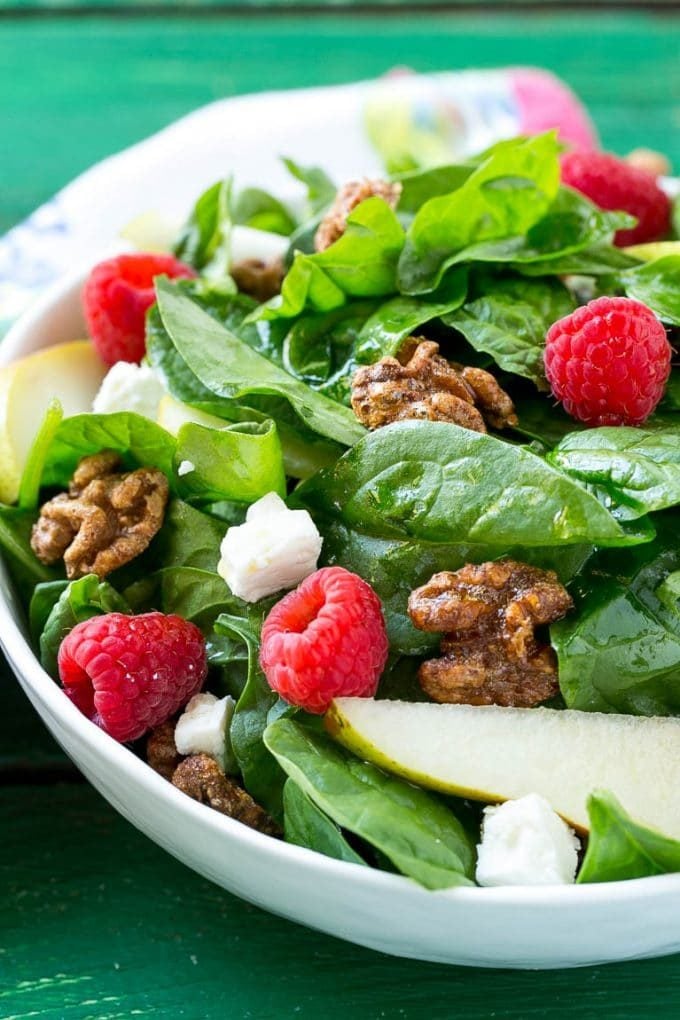 Spinach salad with fruit, feta cheese and candied walnuts.