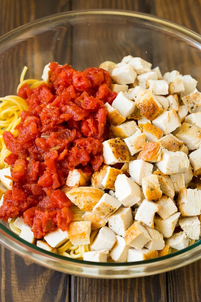 Diced chicken, tomatoes and spaghetti in a bowl.