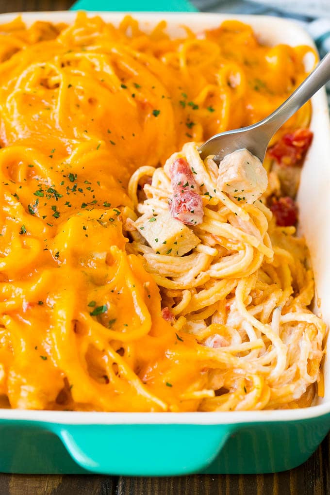 A fork serving up a portion of creamy chicken spaghetti.