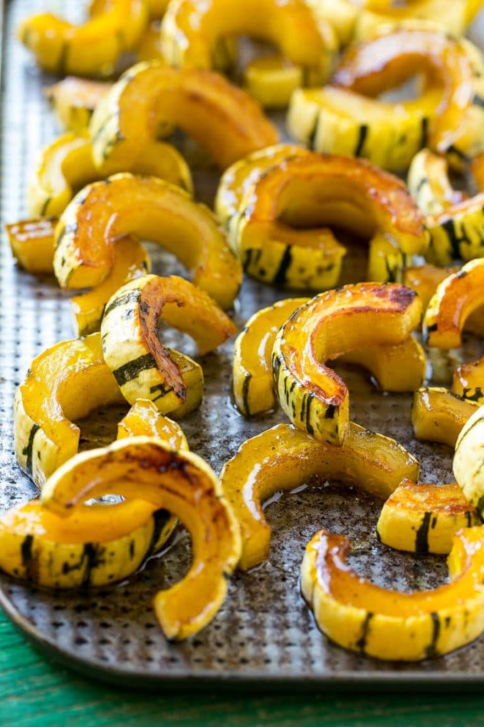 A delicata squash recipe with brown sugar roasted squash on a sheet pan.