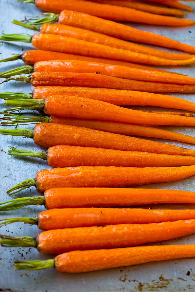 Roasted honey carrots on a sheet pan.