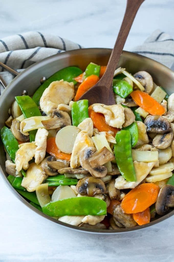 Moo goo gai pan with chicken and vegetables in a skillet.