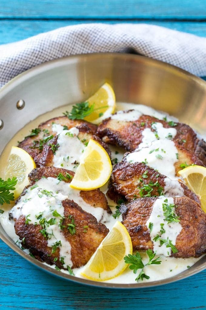 Golden brown pork loin sliced and topped with sauce.