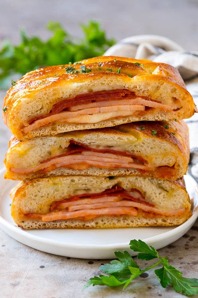 A stromboli recipe with pepperoni, ham and cheese wrapped up in pizza dough and baked.