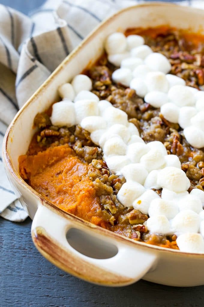 A yams dish with pecan streusel, with a spoonful removed.