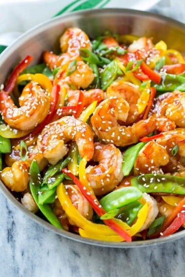 This recipe for teriyaki shrimp stir fry is shrimp and vegetables coated in a homemade teriyaki sauce and served over brown rice. An easy and healthy dinner option that's ready in less than 20 minutes! AD
