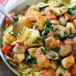 This recipe for Tuscan chicken pasta is creamy pasta topped with seared chicken, tomatoes, kale and mushrooms. An easy and hearty dinner that's ready in no time!