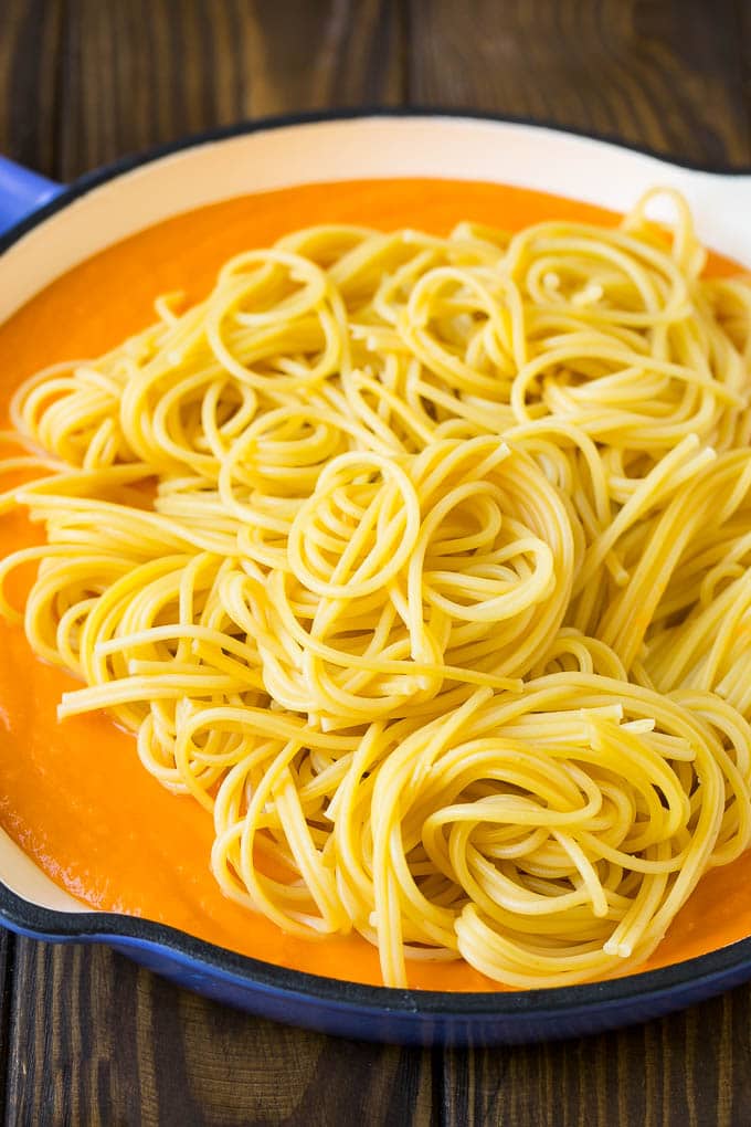 Spaghetti in a pool of butternut squash sauce.