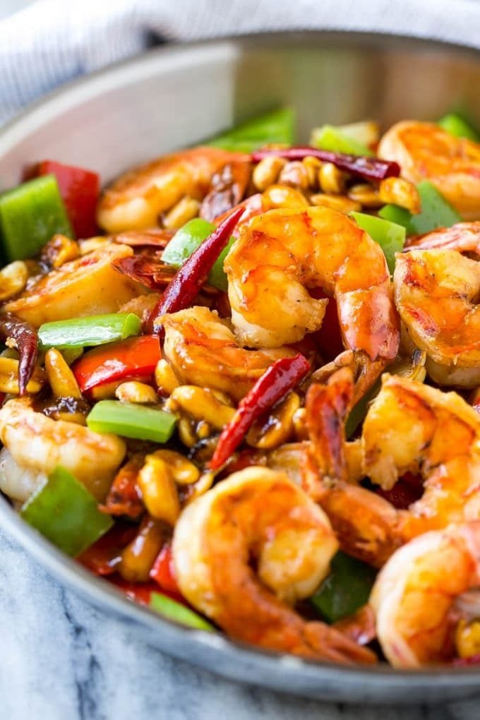 Shrimp in a savory and spicy sauce in a metal pan.