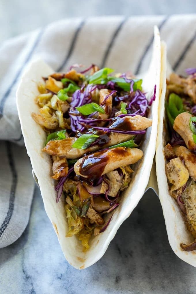 Tortillas filled with stir fried chicken and veggies with eggs and hoisin sauce.