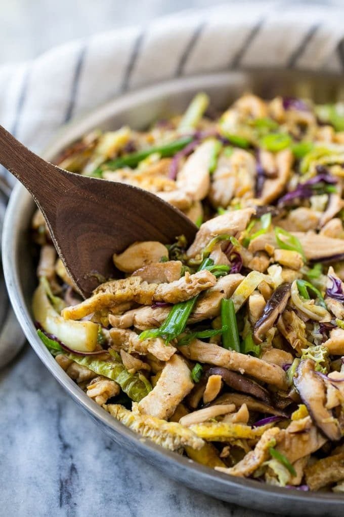 Moo shu chicken in a skillet with vegetables.