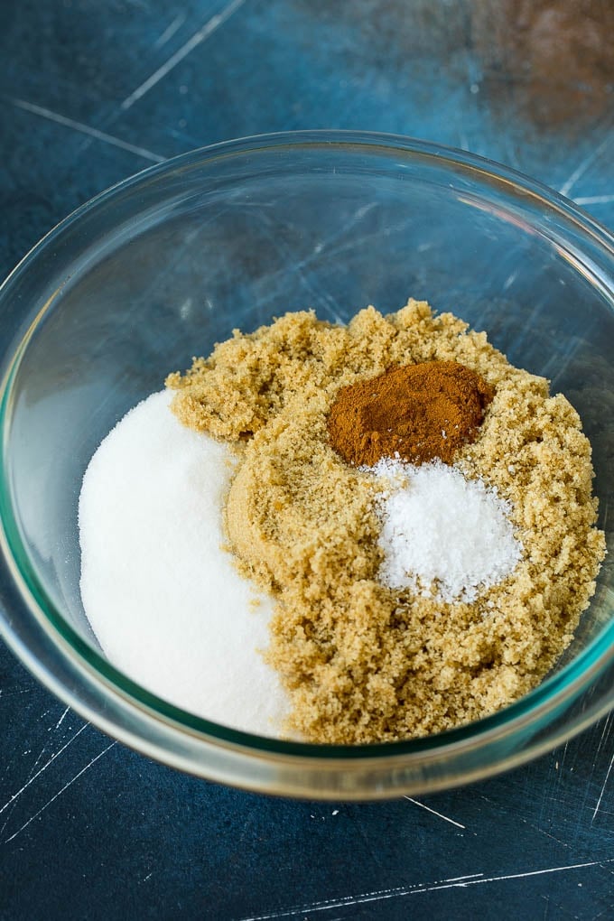 Granulated sugar, brown sugar, cinnamon and salt in a bowl.