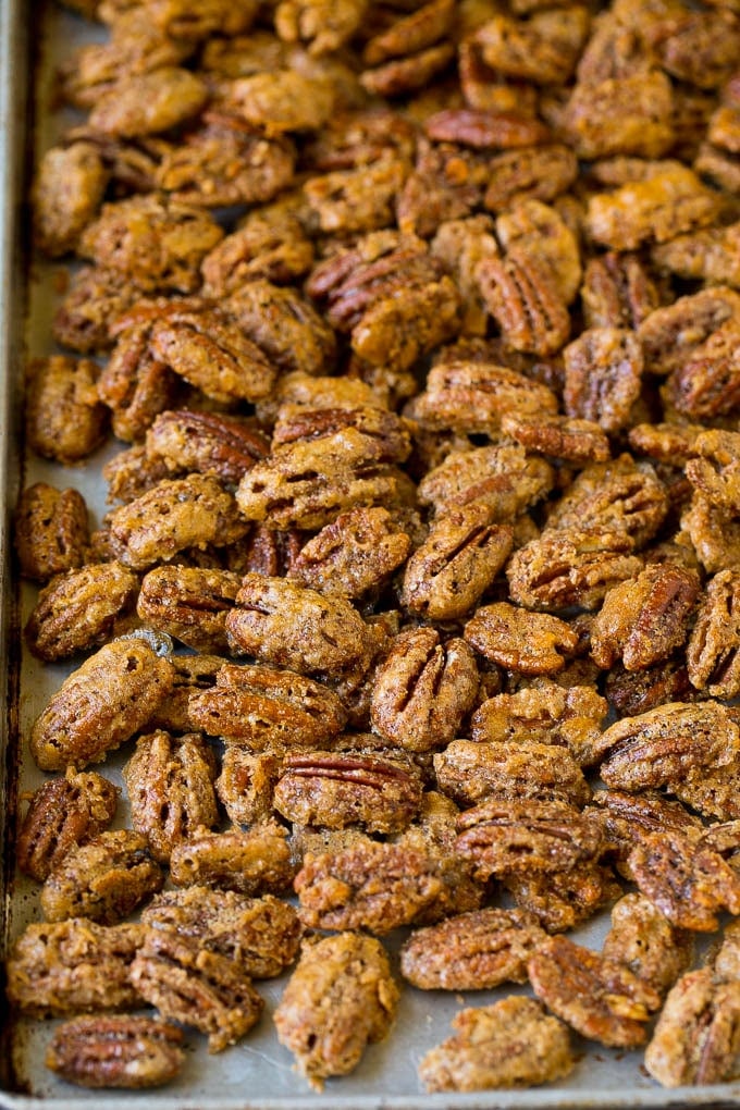 Cooked glazed nuts on a sheet pan.