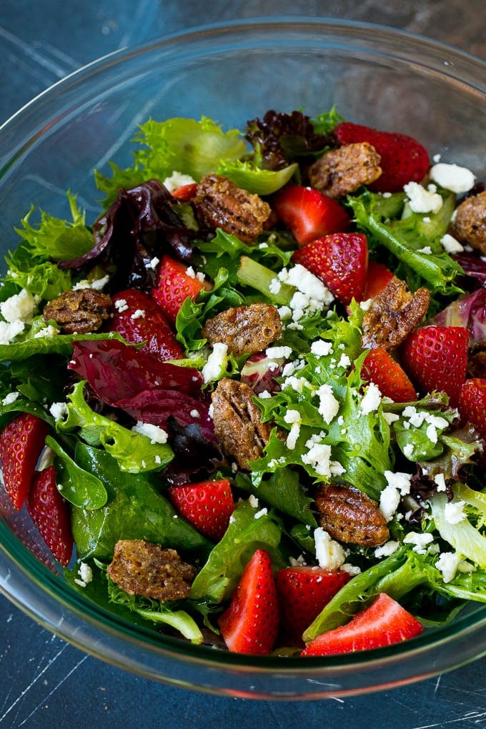 Candied pecans in a salad with strawberries and feta cheese.