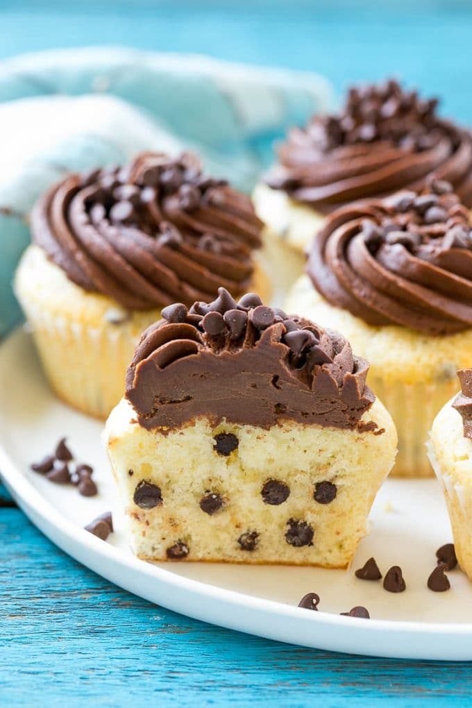 A chocolate chip cupcake cut in half on a serving plate.
