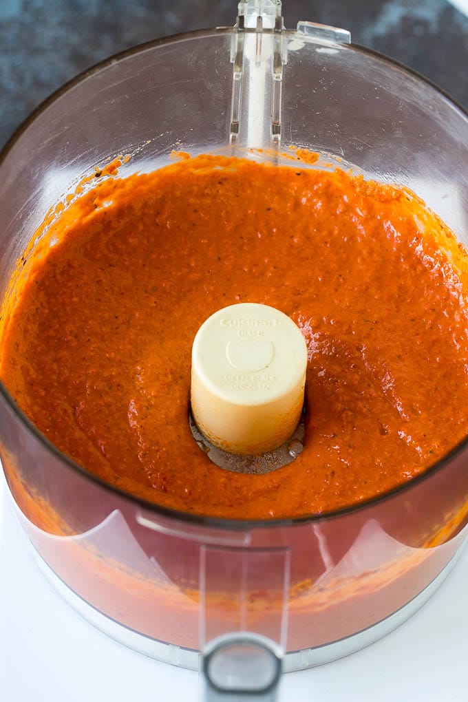 Red pepper dip pureed in a food processor.