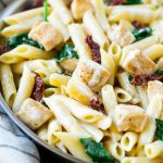 This recipe for sun dried tomato pasta is penne pasta with sauteed chicken and spinach, tossed in a creamy garlic sauce. An easy dinner that the whole family will love!