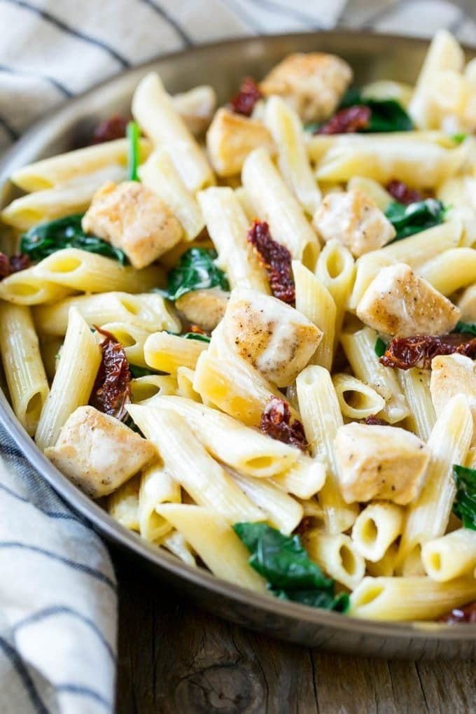 Sun dried tomato pasta with chicken and spinach in a creamy sauce.