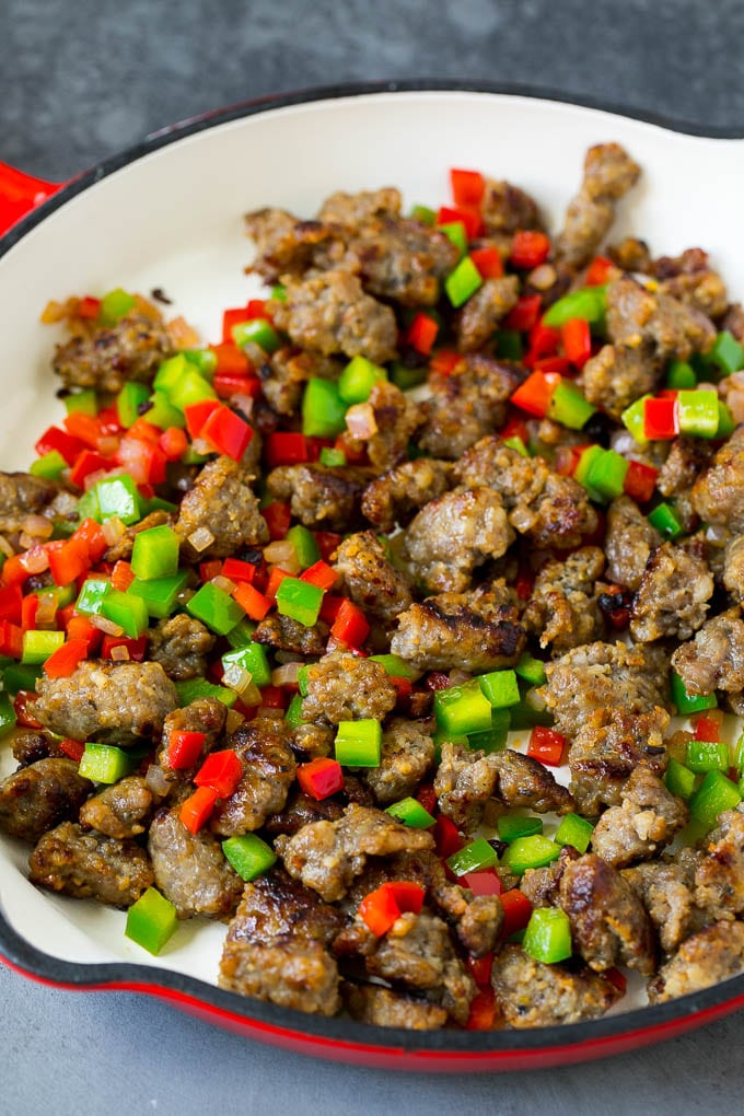 Sausage, onions and bell peppers in a skillet.