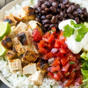 These burrito bowls are loaded with marinated grilled chicken, cilantro lime rice, black beans and a variety of fun toppings. This recipe will become a dinner time staple at your house!