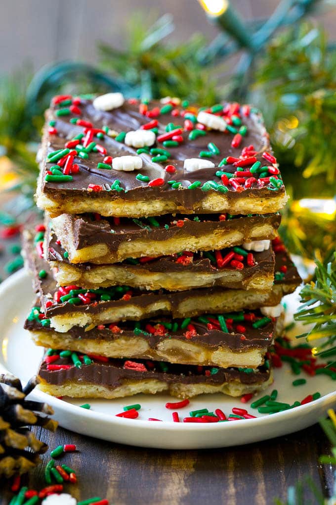 A stack of Christmas crack toffee pieces on a serving plate.