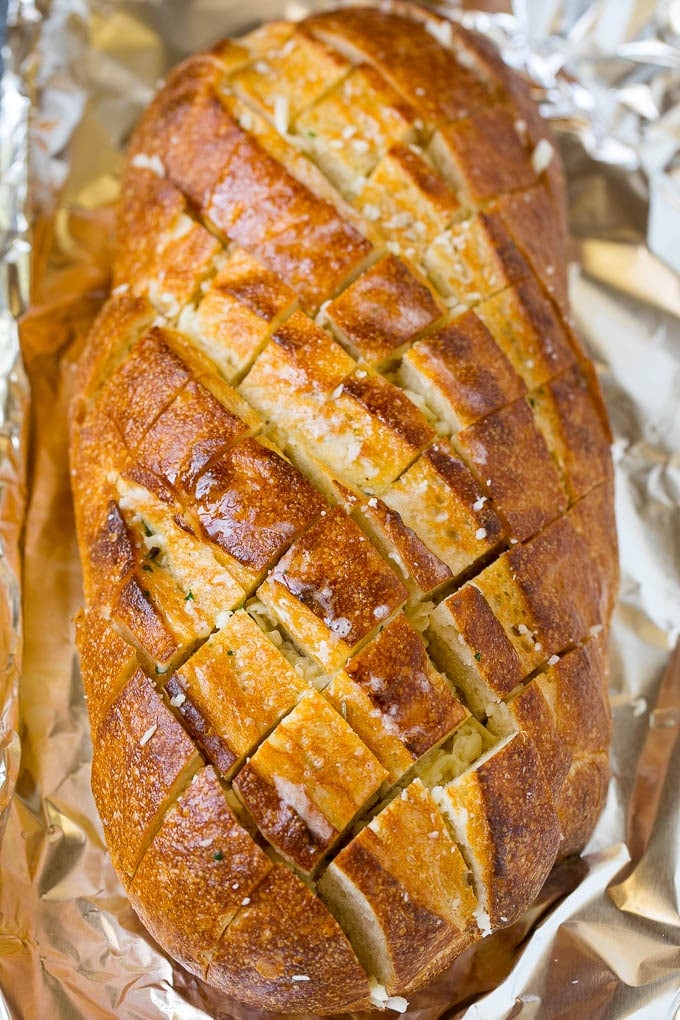 Garlic butter and shredded cheese stuffed into a cut loaf of bread.