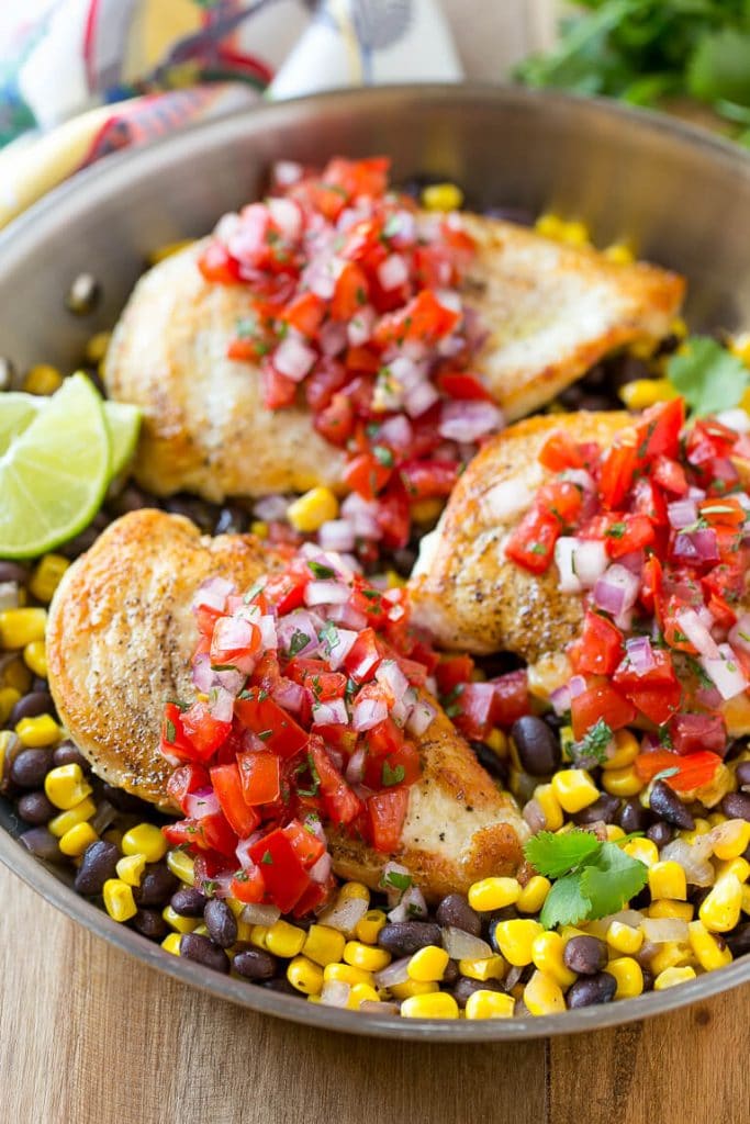 This Salsa Chicken recipe is chicken breasts covered in homemade salsa and served over black beans and corn. It's an easy and healthy dinner that only uses one pan!