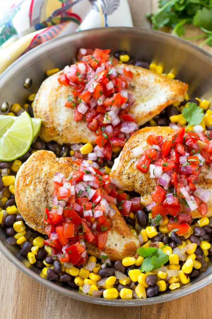 This Salsa Chicken recipe is chicken breasts covered in homemade salsa and served over black beans and corn. It's an easy and healthy dinner that only uses one pan!