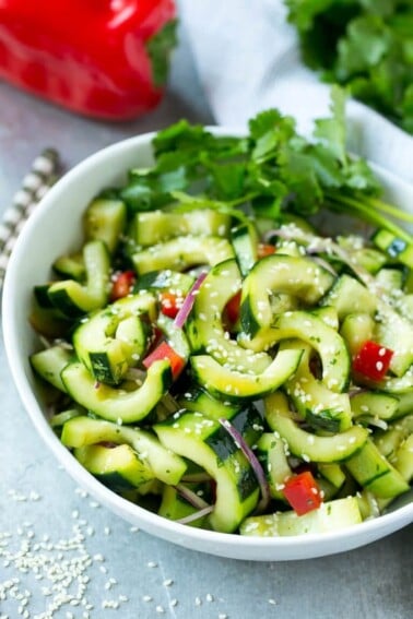 This recipe for Asian cucumber salad is cucumbers and colorful veggies tossed in a zesty sesame dressing. The perfect quick and easy side dish!
