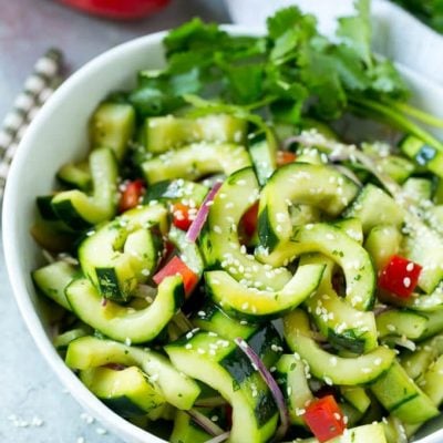This recipe for Asian cucumber salad is cucumbers and colorful veggies tossed in a zesty sesame dressing. The perfect quick and easy side dish!