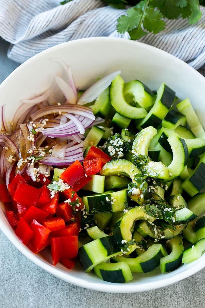 Sliced cucumbers, red peppers and onions with Asian dressing.