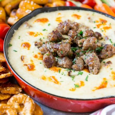 This Wisconsin Brat & Beer Cheese Dip is creamy, cheesy and loaded with bratwurst. It's a hearty appetizer that's perfect for game day entertaining!