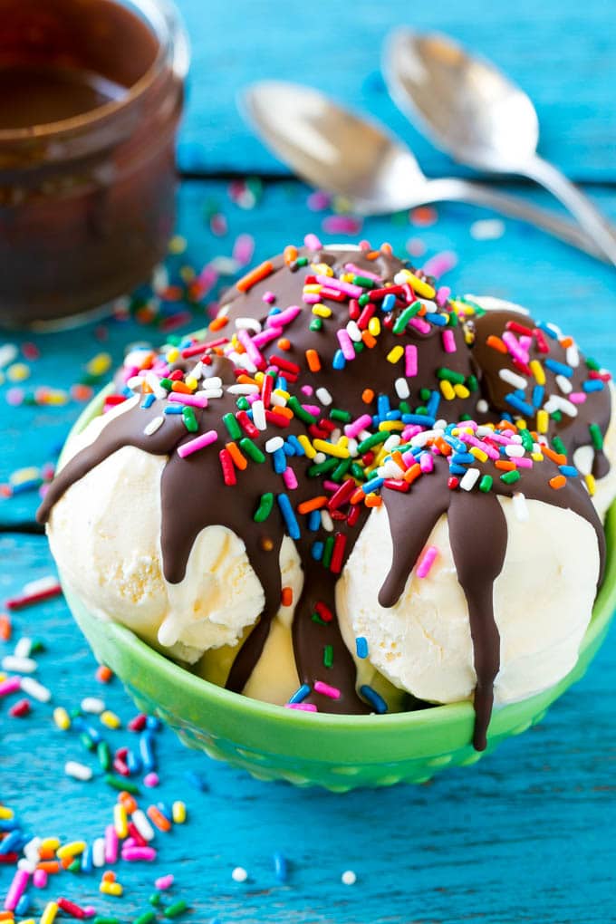 Magic shell over vanilla ice cream with rainbow sprinkles.