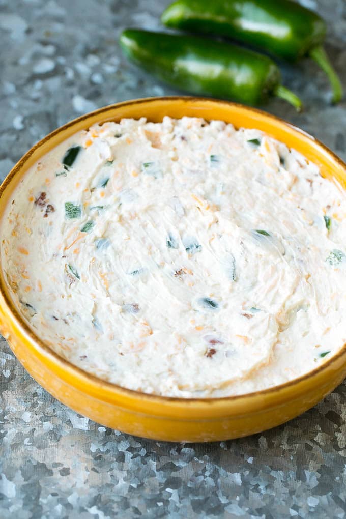 Popper dip spread into a baking dish.