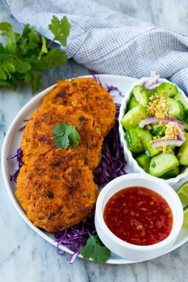 This recipe for Thai fish cakes is sweet and spicy salmon formed into patties and cooked to a golden brown. Serve the fish cakes with a cool cucumber salad and sweet chili dipping sauce for a delicious appetizer or main course!